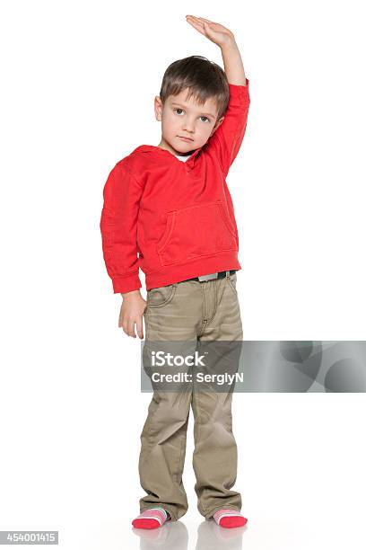 Little Boy Shows His Height Stock Photo - Download Image Now - Boys, Standing, Tall - High