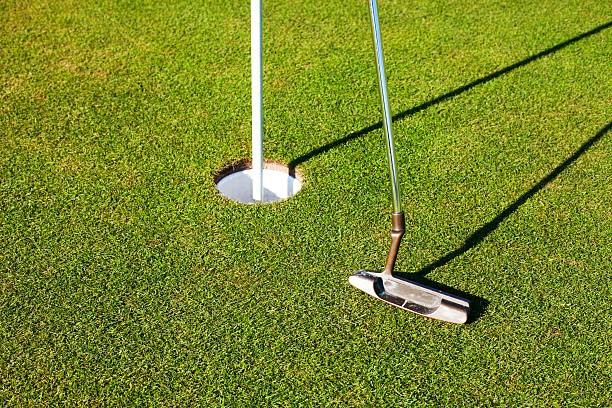 istock Golf club and cup on green, closeup 454039741