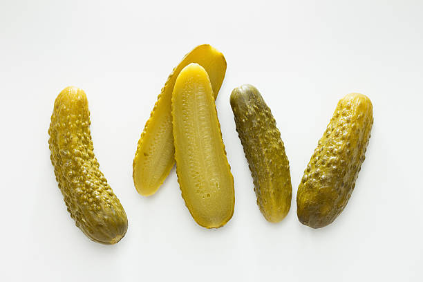 Gherkins Pickled gherkins, whole and halved dill pickle stock pictures, royalty-free photos & images