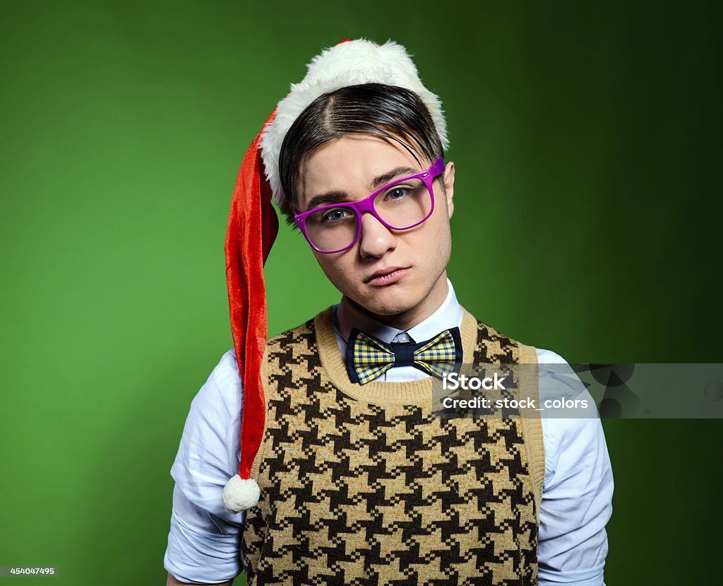 sad nerd geek portrait being sad wearing santa hat. Christmas Stock Photo