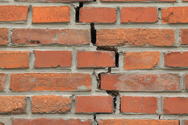 istock crack of red brick wall 454049603