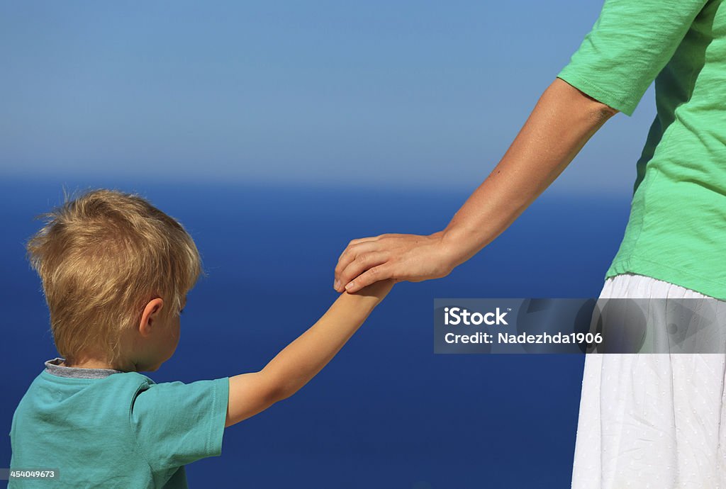 mother and son holidng hands on sea vacation family holding hands on sea vacation, family vacation concept Child Stock Photo