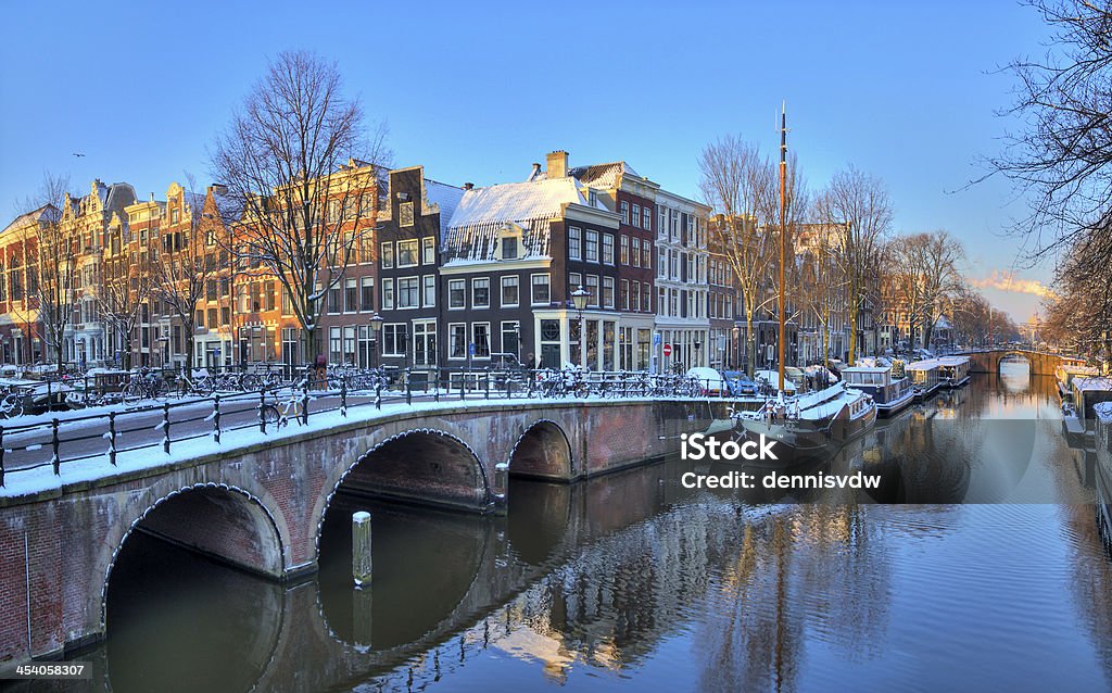 Amsterdam morning canal bridge Beautiful early morning winter view on one of the Unesco world heritage city canals of Amsterdam, The Netherlands. HDR Amsterdam Stock Photo