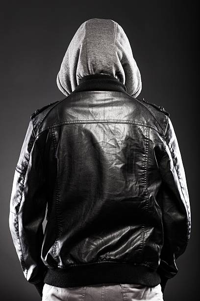 istock Young man in leather jacket and hood rear view 454063311