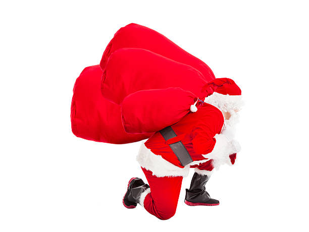 istock santa claus carrying heavy gift bags 454069065