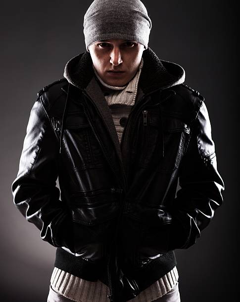istock Young man in winter clothes shivering from cold 454071083