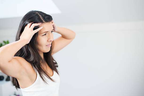 istock Young woman with a migraine headache 454089075