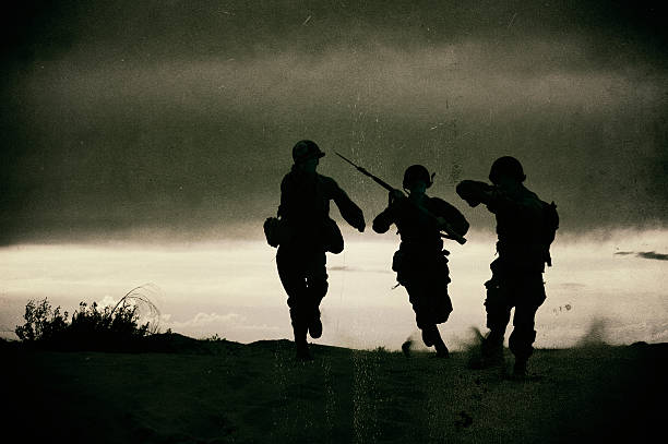 Vintage Photo Of WWII Action Silhouette - Wet Plate Effect Three WWII Soldiers Defending Their Position. Guns and Bayonetts out and ready. This image has a "wet plate" look about it that adds to realism. You will see grain, scratches, spots, dust and other such aged related photo conditions. Copy Space available on left of page, above and below and to the right of the soldiers. us military silhouette stock pictures, royalty-free photos & images