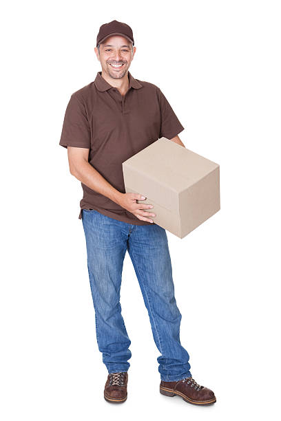 istock Happy Delivery Man Holding Cardbox 454103511