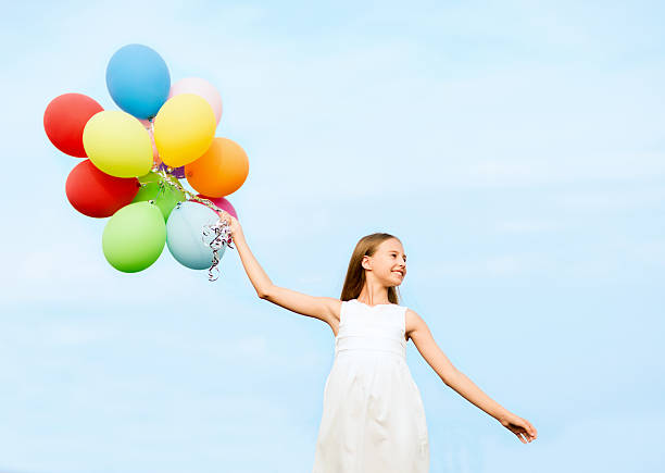 istock happy girl with colorful balloons 454107475