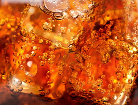 Background of cola with ice and bubbles