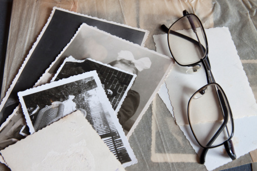 A group of old photographs with the glasses, in the photo album.