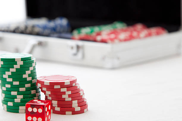 Gambling chips with poker suitcase in background stock photo
