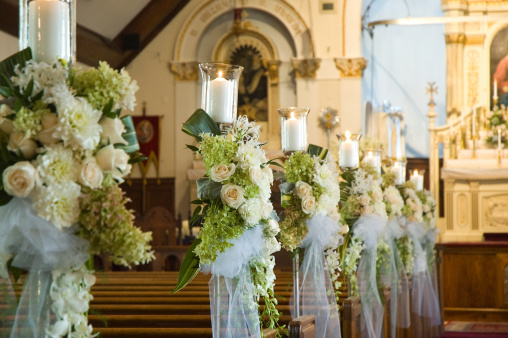 White orchids and roses with greens at a church weddingWhite orchids and roses with greens at a church wedding