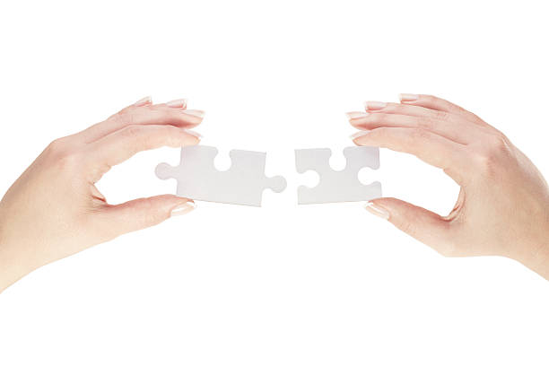 istock Hands holding two pieces of blank puzzle 454124253