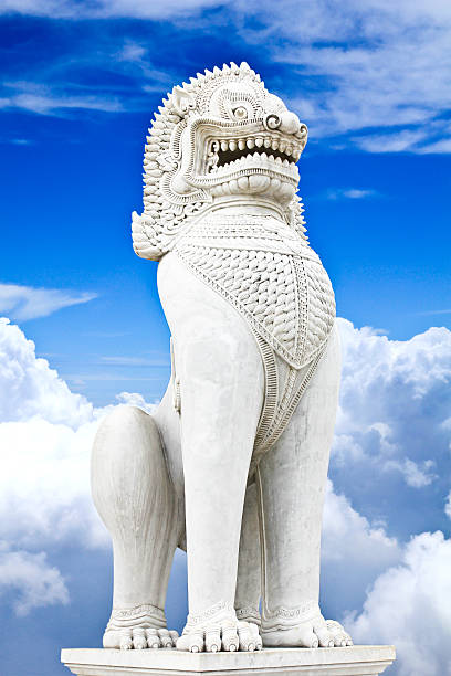 istock Antique guardian lion sculpture on blue sky background. 454126043
