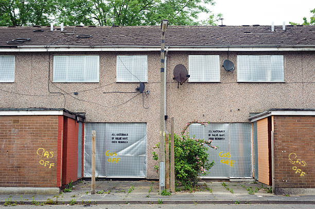 SALFORD, UK - JUNE 2013 - Abandoned terraced housing with metal shutters waiting for demolition in Salford, UK.
