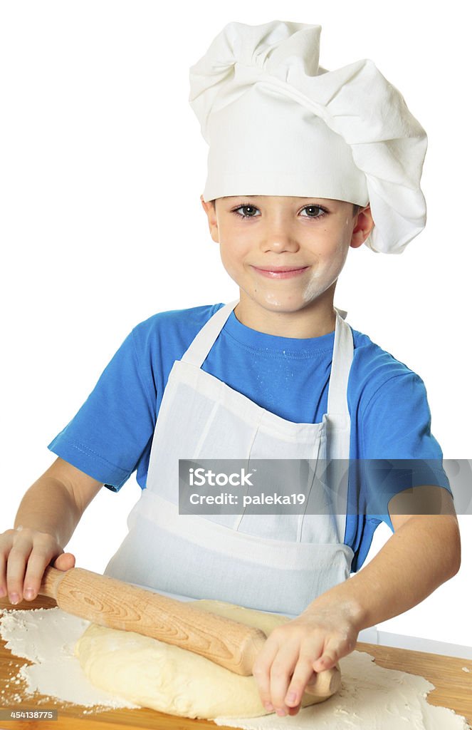 Cook boy Six years old cook boy with rolling pin isolated on white Apron Stock Photo