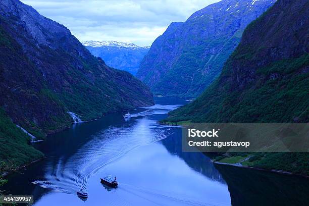 Naeroyfjord Mountains And Ship Cruises Crossing Water Norway Stock Photo - Download Image Now