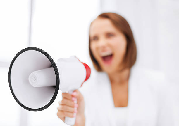 istock strict businesswoman shouting in megaphone 454140587