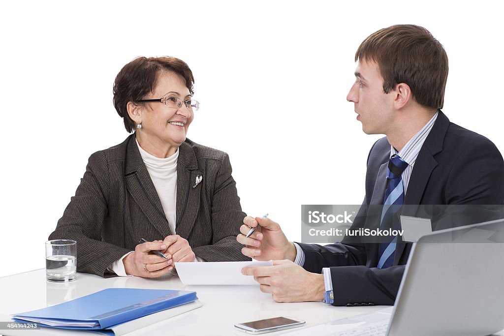 Elderly woman with a financial advisor Manager advises the elderly woman in the office,isolated on white background Active Seniors Stock Photo