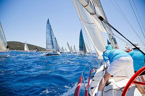 istock Saluting crew on a boat among a fleet in the ocean 454155181