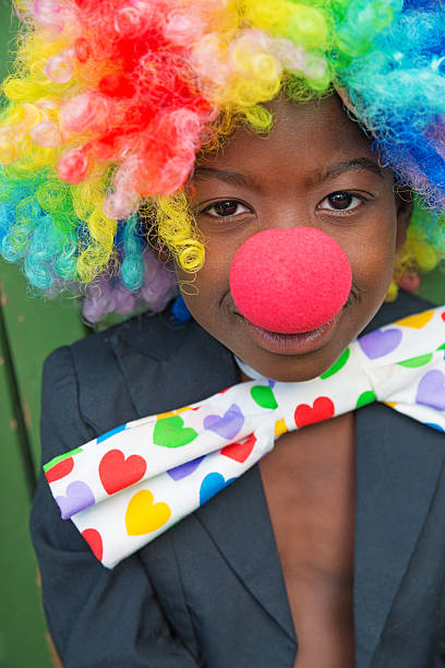 istock Expressive little black boy with a clown costume. 454158127