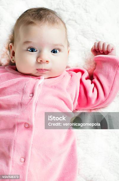 Cute Baby Girl Lying On The Bed Stock Photo - Download Image Now - Baby - Human Age, Crib, Vertical