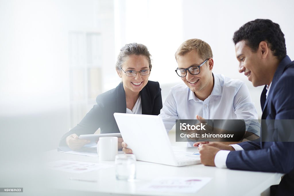 Networking Portrait of smart business partners using laptop at meeting Expertise Stock Photo