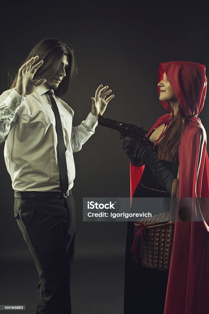 Red Riding hood with gun Red Riding Hood with gun and Bad Wolf with hands up Adult Stock Photo