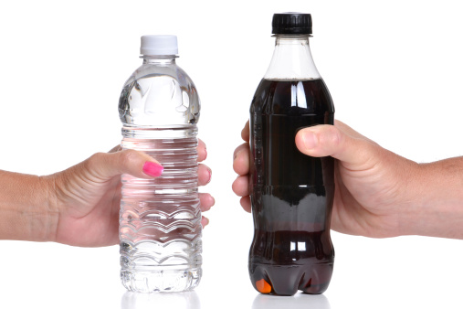 bottled water and bottle of soda white background