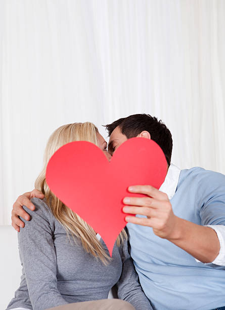 istock Romantic couple holding a red heart 454173123