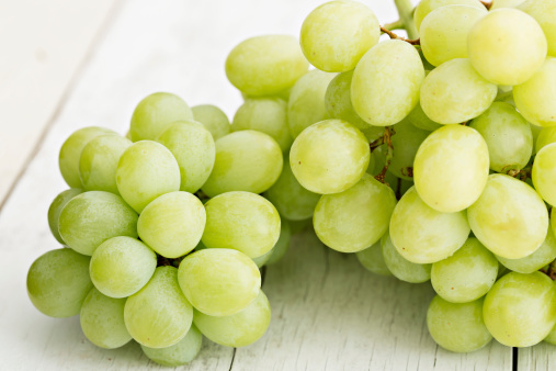 A high angle close up shots of freshly picked sweet green grapes.