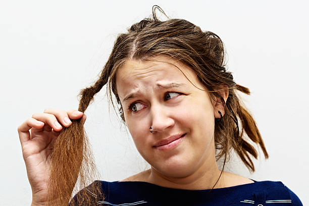 mulher jovem frustrado frowns no seu desesperadamente cabelo assanhado - hippie women dreadlocks human hair - fotografias e filmes do acervo