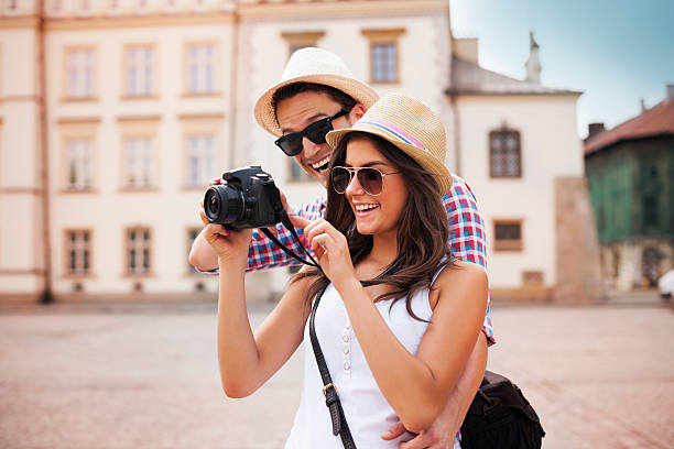istock Young couple looks at photos on camera 454180697