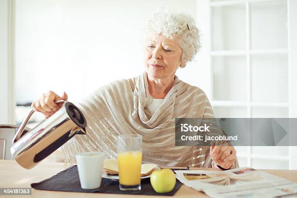 Senior Woman Having Breakfast Stock Photo - Download Image Now - Dining, Senior Adult, 60-69 Years