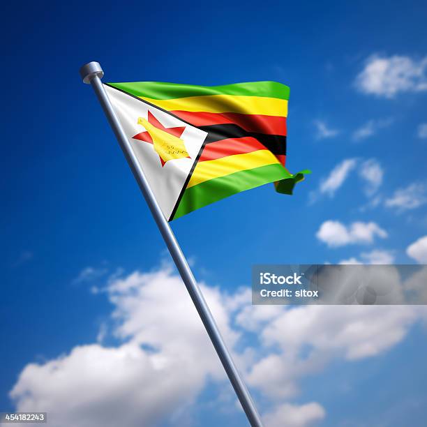 Flag Of Zimbabwe Against Blue Sky Stock Photo - Download Image Now - Zimbabwe Flag, Flag, Zimbabwe