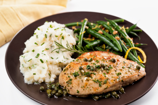 Sauteed chicken breast in a lemon-caper-garlic sauce; could work for veal piccata.  Served with chive mashed potatoes and green beans with pine nuts and lemon zest.  Shallow DOF.