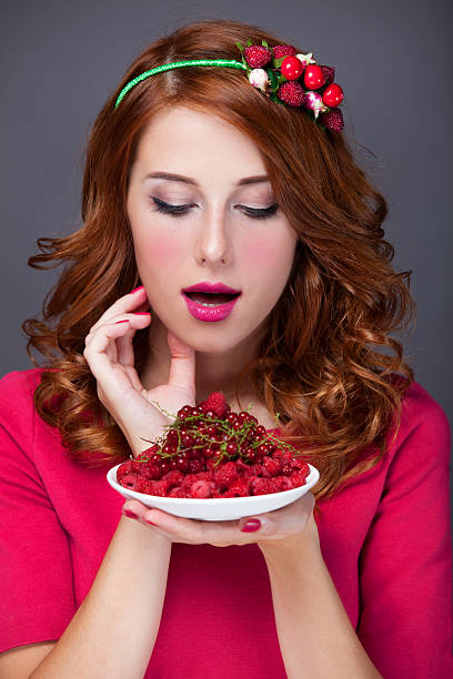 istock Redhead women with berries 454186125