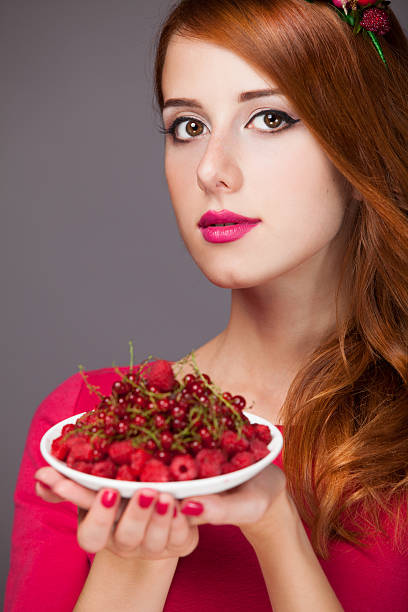 istock Redhead women with berries 454186693