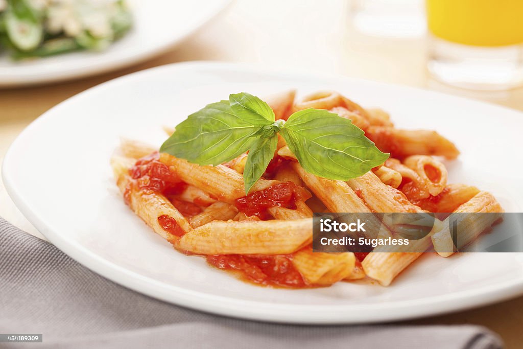 Penne with tomato sauce Penne with tomato sauce with basil and parmesan cheese Basil Stock Photo