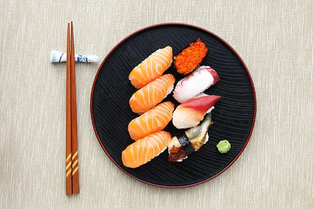 top view of a Sushi mix on the plate with chopsticks