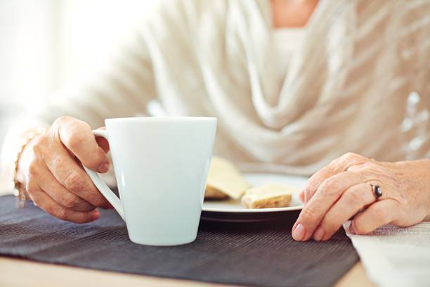 istock Wrinkled Hands with a Cup of Coffee 454198191