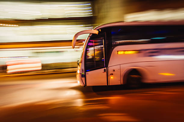 Large Tourist Bus Travels Fast In The City Large Tourist Bus Travels Fast In The City coach bus photos stock pictures, royalty-free photos & images