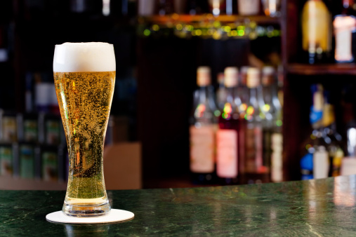 glass with beer on the background of the bar