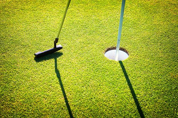 istock Golf club and cup on green, closeup 454213429