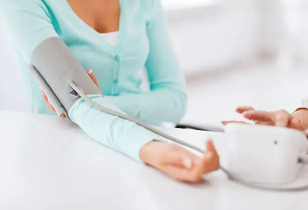 Photo of doctor measuring patient blood pressure with tonometer