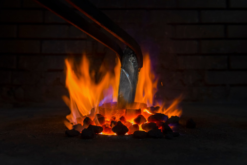 Smelting silver in crucible for making jewelry.