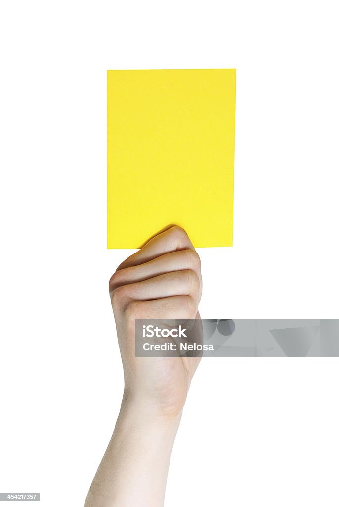 Mano agarrando una tarjeta amarilla - Foto de stock de Amarillo - Color libre de derechos