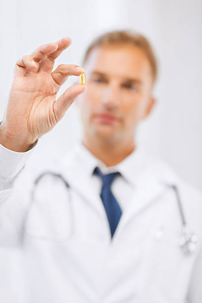 istock doctor with pill in hospital 454220191